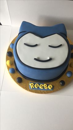 a blue and white cake with a face on it