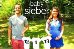 a man and woman standing next to each other in front of a sign that says baby sieber