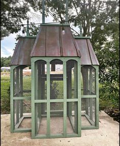 a green chicken coop with a red roof