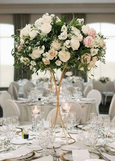 there is a vase with flowers on top of the table at this wedding reception in an elegant setting