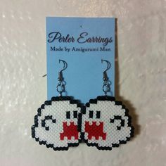 a pair of pixel earrings with coffee mugs on the front and bottom, in black and white