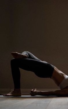 a woman is doing yoga on the floor