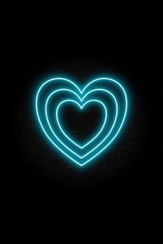 two heart shaped neon lights in the dark