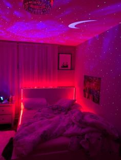 a bedroom with pink lights and stars on the ceiling