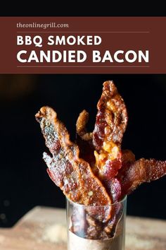 bacon is in a small glass on a wooden table with the words bbq smoked candied bacon