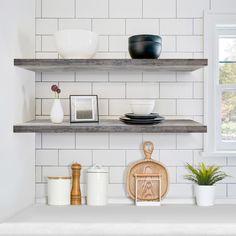 the shelves in the kitchen are filled with plates and bowls