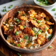 a wooden bowl filled with food on top of a table