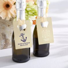 two bottles of wine with tags attached to them