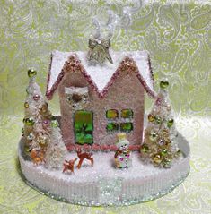 a small pink house decorated with christmas decorations