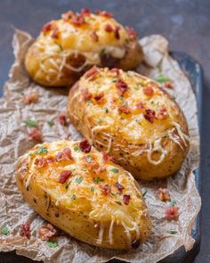 three baked potatoes with bacon and cheese on top