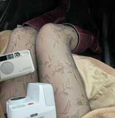 there is a camera sitting on the back of a car seat next to an ipod