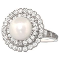 Circa 1910, Platinum, by Black Starr & Frost, New York. Breathtakingly beautiful, the Natural Pink tone American River Pearl (GIA Report) in this ring is truly dreamy. Delicately surrounded by .80 carats of brilliant white diamonds (F color, VS clarity), the look is charming, chic, timeless. A superb handmade undergallery and band complete the picture. Demonstrating Black, Starr, and Frost's commitment to excellence, the sublime design is underscored by quality materials and meticulous fabricati Luxury Pearl Ring With Rose Cut Diamonds, Luxury Round Pearl Ring With Rose Cut Diamonds, Oval Platinum Pearl Wedding Ring, Antique Cocktail Ring, River Pearls, Black Engagement Ring, Pearl Rings, Pearl And Diamond Ring, Sapphire Diamond Ring