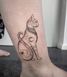 a black and white cat tattoo on the right side of the leg, with space around it