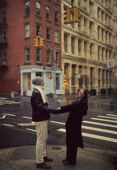 a man and woman holding hands on the street