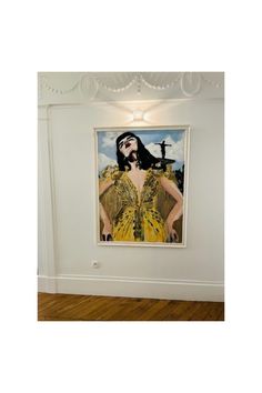 A view of the painting 'Ready or Not' by Veronica Wells. The painting depicts a young woman wearing a gold dress designed by Jenny Packham. That same dress was worn by HRH The Duchess of Cambridge or the world premier of 'James Bond, No Time to Die' in September 2021. British Design, James Bond