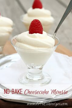 three small desserts with raspberries and whipped cream in glass dishes on a wooden table