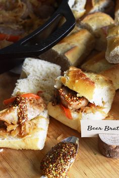 bread with meat and vegetables sitting on a cutting board