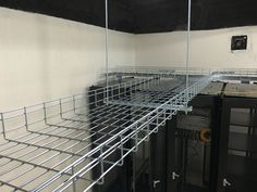 the room is filled with metal racks for storage and other things to be stored in