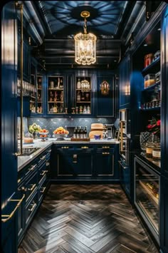 a kitchen with dark blue cabinets and wood flooring is seen in this image from the inside