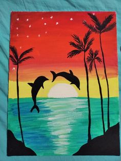 two dolphins jumping out of the water in front of palm trees and an orange sunset