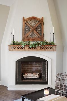 a living room with a fire place and a clock on the wall above it's mantle