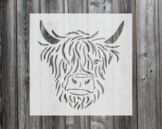 a wooden wall with a stencil of a bull's head