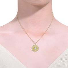 This vintage-inspired medallion pendant necklace features a textured pattern for a luxurious, unique look. A heart-shaped cubic zirconia solitaire takes center stage framed by a halo of cubic zirconias. A delicate cable chain suspends this pendant secured by a lobster clasp, all in brightly polished 14k yellow gold plated. Cubic Zirconia Medallion Necklace Gift, Elegant Medallion Necklace With Delicate Chain, Gold Cubic Zirconia Medallion Jewelry, Gold Medallion Jewelry With Cubic Zirconia, Elegant Gold Medallion Necklace With Flower Pendant, Gold Cubic Zirconia Medallion Necklace, Elegant Gold Medallion Charm Necklace, Elegant Medallion Necklace With Coin Pendant For Anniversary, Elegant Coin Pendant Medallion Necklace For Anniversary