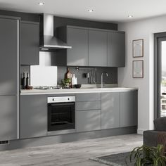 a modern kitchen with grey cabinets and white counter tops is seen in this image from the living room