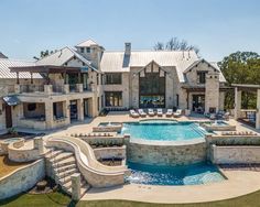 a large house with a pool in front of it