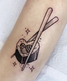 a tattoo on the leg of a person with chopsticks