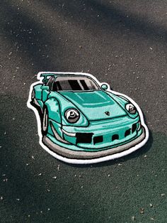 a blue car sticker sitting on the ground