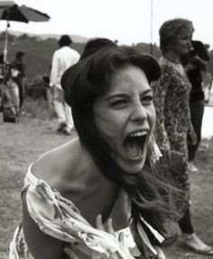 a woman with her mouth open and people in the background