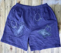 Blue Fish was an ICONIC 90s brand, known for their hand-printed designs. These lovely purple shorts are 'Lagenlook', meant to be casual, baggy, and comfy. Two large pockets adorned with an eggplant and a shell as well as the letter Q. No size listed, but these would be a small. Condition: Very Good. Pre-owned. Iconic 90s, Blue Fish, Purple Shorts, Vintage Shorts, Eggplant, Short Outfits, Purple Color, Fashion Art, Organic Cotton