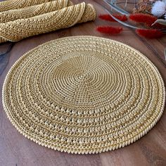 two round rugs sitting on top of a wooden floor next to vases filled with flowers