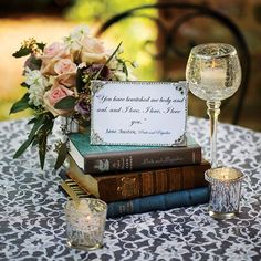 a table topped with books and wine glasses