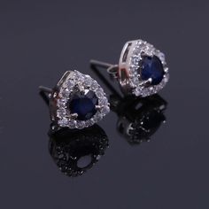 "This Sterling Silver Earring features an Elegant Art With Natural Blue Sapphire Gemstone. The cavity is made from genuine solid 925 sterling silver and stamped as S925. This Jewelry is Lead free. ITEM DESCRIPTION Item Code: JAER31 Metal: 925/92.5 Sterling Silver Gemstone: Natural Blue Sapphire Faceted Gemstone Shape: Round Gemstone Size: 5X5 MM Earring Shape: Triangle Earring Length: 9 MM Earring width: 9 MM Surrounded Stones: Zircon Weight: 2.20 gm **Keep the jewelry away from direct heat, wat Sapphire Halo Earrings In Sterling Silver, Sapphire Earrings With Halo Setting As Gift, Sapphire Earrings With Halo Setting For Gift, Blue Halo Earrings For Wedding, Formal Sapphire Earrings With Halo, Sterling Silver Halo Diamond Earrings As Gift, Sterling Silver Bridal Earrings With Halo Design, Sterling Silver Halo Earrings For Party, Silver Halo Cluster Earrings Gift