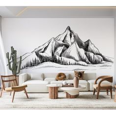 a living room with mountains painted on the wall