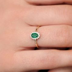 Item Details
• Made to Order.• Gold KT: 14K• Custom Gold Color: Rose Gold, Yellow Gold, White Rhodium• Gemstone Cut: Oval Emerald // Round Diamonds• Oval Emerald: 1 Oval Emerald 6x4MM in Size• Round Diamonds: 14 Round diamonds 1.30MM in Size• Total Emerald CTW: 0.40ctw• Total Diamond CTW: 0.15ctw• Diamond Color-Clarity: G Color SI Clarity• Setting Type: Prong• Band Width: 1.35mm
 

Description
A stunning accent piece, our emerald halo diamond ring will add the finishing touch to your evenin Dainty Gold Band, Natural Emerald Rings, Measure Ring Size, Local Jewelry, Platinum Ring, Emerald Earrings, Halo Diamond Ring, Oval Diamond, Oval Cut