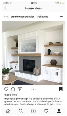 a living room with white cabinets and shelves