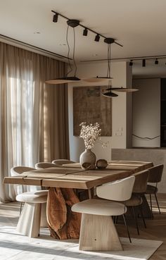 a dining room table and chairs in front of a window