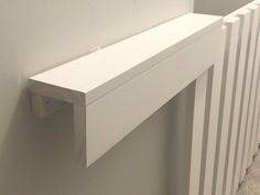 a white radiator is mounted on the wall