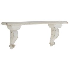 a white wooden shelf with two brackets on it