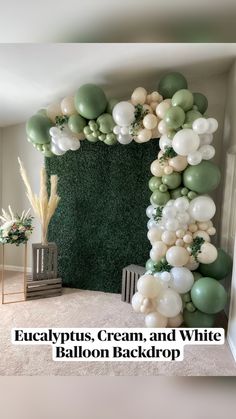 a balloon arch with white and green balloons