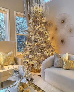 a living room with a christmas tree in the corner and gold decorations on the walls