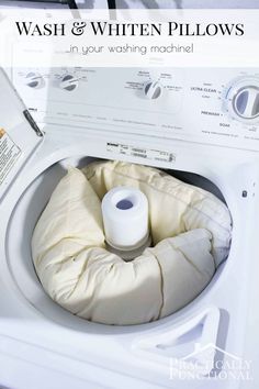 a white washer with a roll of toilet paper in it