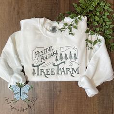 Show your love for Festive Foliage Tree Farm in this comfortable, stylish crewneck sweatshirt. Featuring a festive embroidered logo, this classic piece is sure to keep you looking and feeling great! This crewneck is unisex. This is a physical product. Crewneck is embroidered. Rhinestone Hoodie, Nurse Hat, Embroidered Crewneck, Easter Outfit, Thanksgiving Outfit, Tree Farms, Feeling Great, School Outfits, Embroidered Patches