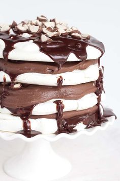 a cake with chocolate icing and nuts on top