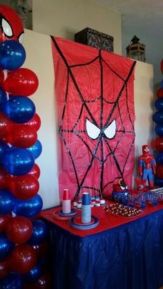 a spiderman themed birthday party with balloons