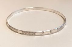 This is a cute bracelet. This sterling silver bangle is made with medium gauge sterling silver and it is about 1/4 inche wide. The bangles shown is 2.5 inches in diameter and will fit most wrists. it is also available 2.25, 2.75 and 3 inches in diameter. It looks great alone of stacked with other bracelets like this one: https://www.etsy.com/listing/569857013 How to measure your hand for a bangle: Make your hand as small as possible, as if you were putting on bangles, bringing your thumb and lit Cute Bracelet, The Bangles, Silver Bangle Bracelet, Bangles Making, Sterling Silver Bangle Bracelets, Grand Junction, Sterling Silver Bangle, Bracelet Sterling Silver, Silver Bangle Bracelets