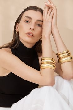 VALÉRE's 'Sienna' cuffs are crafted from24k gold plated brass and embellished with its uniquely designed shape. Polished and refined, style your bangle with a summer dress to let the bangle do all the talking. To make more of a statement layer all three sizes. Details: 24k Gold micron plated brass Nickel, free & lead free Handmade finish Original VALÉRE design featuring branded stamp Measurements: 86x88mm VALÉRE’s luxurious brand aesthetic is reflected through the use of semi-precious natural gemstones, high quality materials and skilful craftsmanship. Each piece of VALÉRE jewellery is handmade by experienced artisans. All of VALÉRE jewellery is carefully handcrafted which means that each piece of our jewellery possess unique characteristics making them differ slightly in appearance and re Brand Aesthetic, Black Family, 2024 Style, Models Makeup, Wide Bracelet, Refined Style, Gold Plated Bracelets, Shine Bright, Minimal Fashion